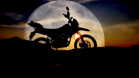 Silhouette of motorcycle on the background of the full moon.の写真素材