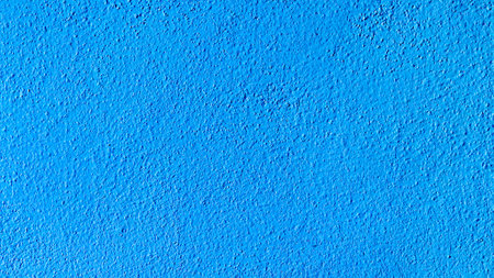 Close-up of a vibrant blue textured wall, ideal for backgrounds or design elements.の写真素材