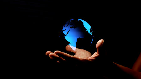 Globe in human hand on dark background. Elements of this image furnished by NASAの写真素材