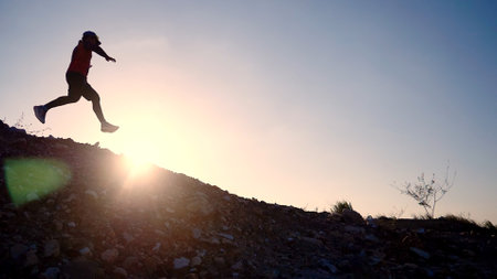 Runner athlete running on mountain peak. woman fitness jogging workout wellness concept.