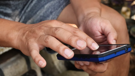 Man using mobile smart phone. Close-up of male hands using smartphone.の写真素材