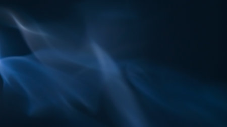 Abstract image of blue smoke swirling against a dark background, evoking a sense of mystery and tranquility.の写真素材