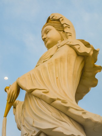 Big  Guan Yin in  in action one hand up touch the moonの写真素材