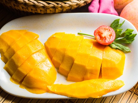 slice of mango on white dish.の写真素材