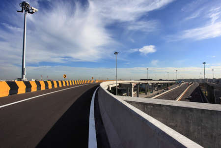 curve road sign with blue skyの写真素材