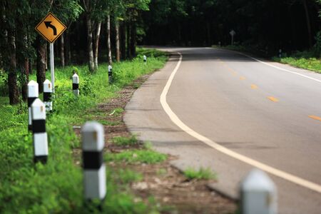 Curve road sign on down hill の写真素材
