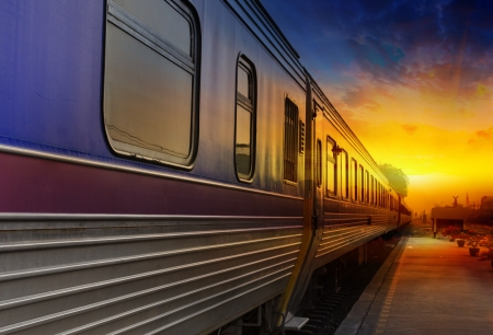 Train passing by in orange sunsetの写真素材