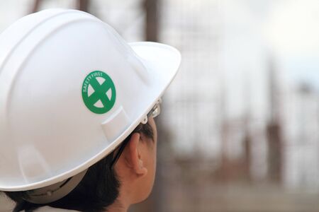 Worker and the blurred construction in background with space for your textの写真素材