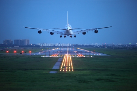 passenger plane fly up over take-off runway from airportの写真素材