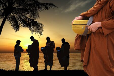 Silhouettes of monks on the beach, Thailandの写真素材