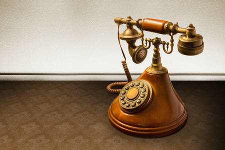 Vintage telephone over striped wallpaperの写真素材