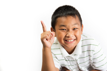 Happy boy pointing with his fingerの写真素材