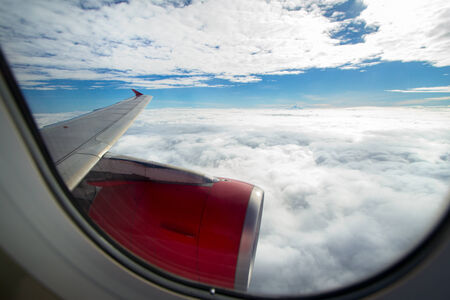 Clouds and sky as seen through window of an aircraftの写真素材