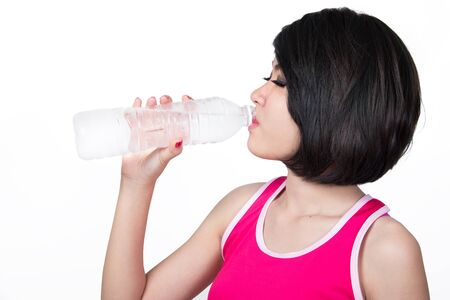 portrait of young woman drinking waterの写真素材