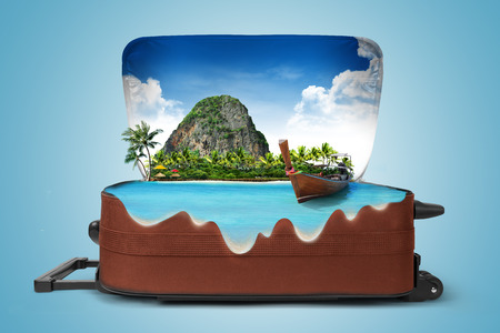 Open suitcase with a tropical island inside. Travelingの写真素材