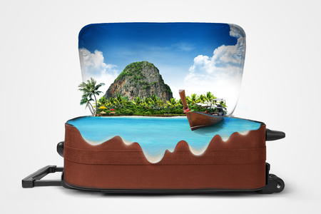 Open suitcase with a tropical island inside. Travelingの写真素材