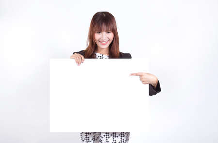 Young woman is holding blank banner, isolated over whiteの写真素材