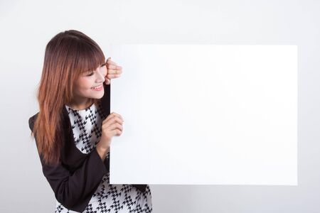 Young woman is holding blank banner, isolated over whiteの写真素材