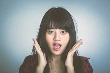 Portrait of a surprised girlの写真素材
