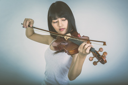 beautiful girl playing the violinの写真素材