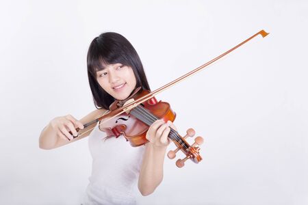 beautiful girl playing the violin, isolated on white backgroundの写真素材