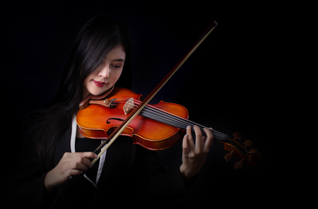 Playing the violin. Musical instrument with hands on dark background.の写真素材