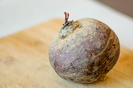 Fully visible beetroot from the top of wooden boardの写真素材