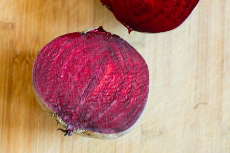 Top view of a halved beetroot with wooden backgroundの写真素材