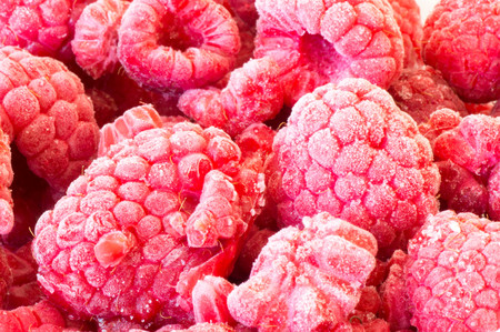 Close-up view of a pile of frozen raspberryの写真素材