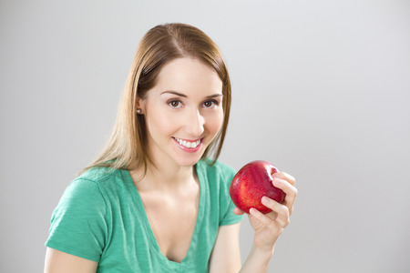 Beautiful girl with appleの写真素材