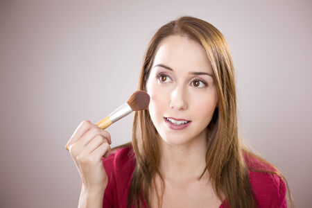 Young woman applying blushの写真素材