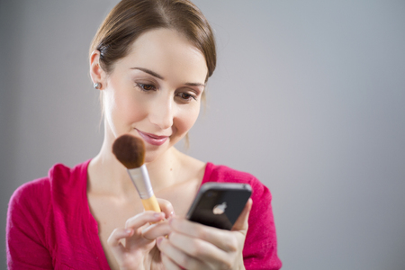Young woman applying blushの写真素材