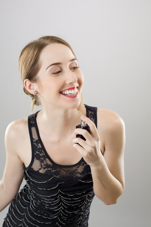 Closeup of a woman applying perfumeの写真素材