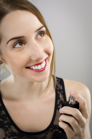 Beautiful woman with bottle of perfumeの写真素材