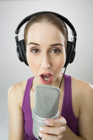 Woman singing Into Microphoneの写真素材