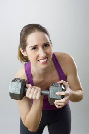 Woman lifting heavy weightの写真素材