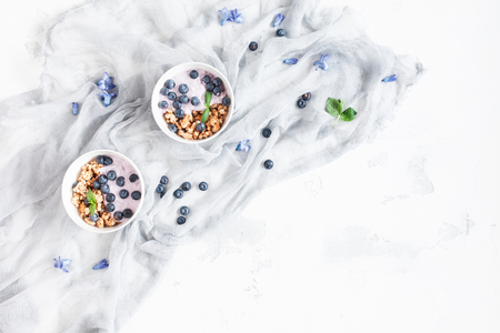 Healthy breakfast with yogurt, muesli and berries. Flat lay, top viewの写真素材