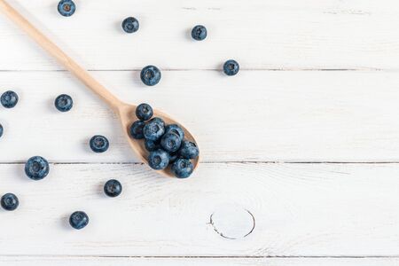 blueberry on wooden spoon top viewの写真素材