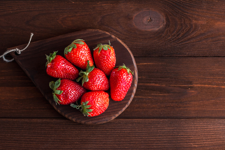 strawberry on the plate on wooden backgroundの写真素材