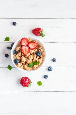 healthy breakfast with muesli and berries, top view, flat layの写真素材