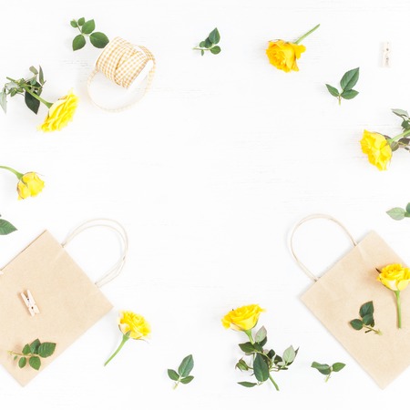 Flowers composition. Gift and yellow flowers on white background. Flat lay, top view, squareの写真素材
