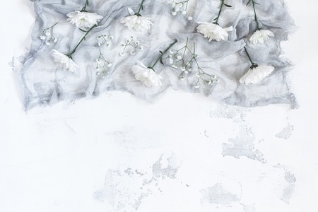 Composition with white flowers on gray background. Flat lay, top viewの写真素材