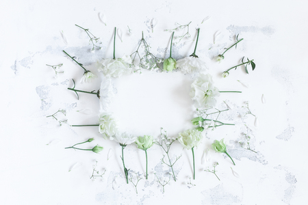 Floral composition. Frame with white flowers on gray background. Flat lay, top viewの写真素材