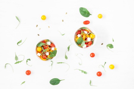 Spring salad with arugula, feta cheese, bell pepper and cherry tomatoes. Flat lay, top viewの写真素材