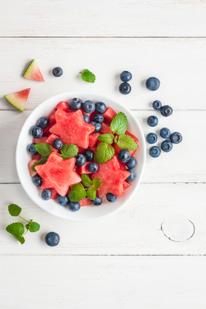 Summer fruit salad of watermelon and blueberries, top view, flat layの写真素材