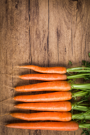 fresh carrots on a wooden backgroundの写真素材