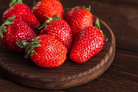 strawberry on the plate on wooden backgroundの写真素材