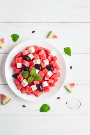 Summer salad of watermelon, feta cheese and olives, top view, flat layの写真素材