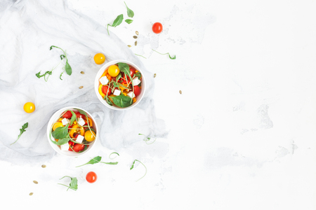 Spring salad with arugula, feta cheese, bell pepper and cherry tomatoes. Flat lay, top viewの写真素材
