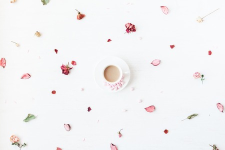 Flowers composition. Cup of coffee, dried flowers and leaves. Top view, flat layの写真素材